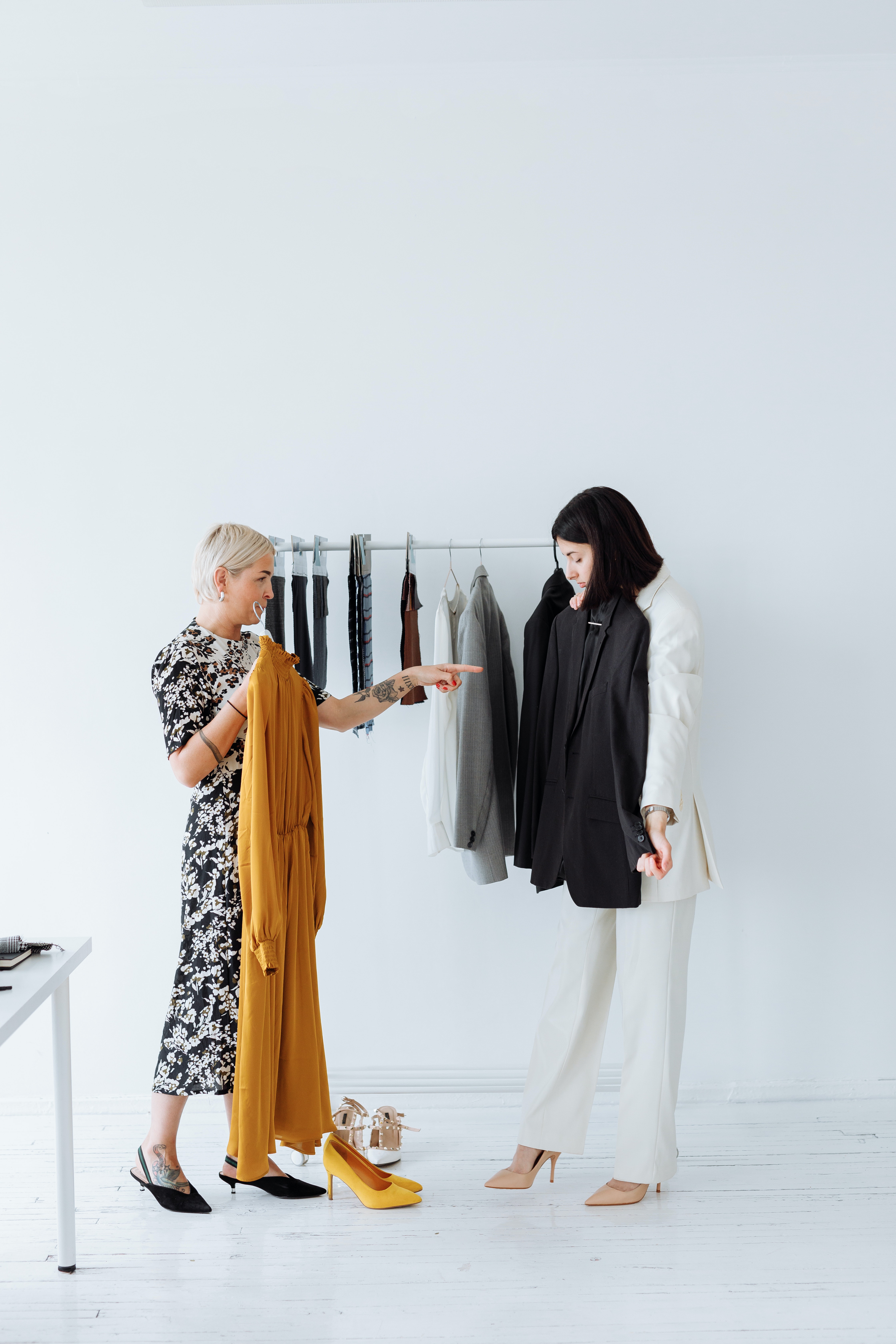 women looking at clothing rack